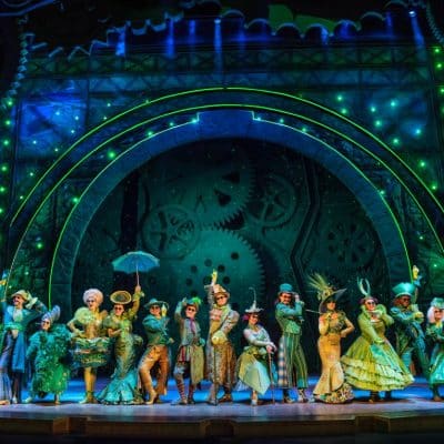 Wicked ensemble cast on stage